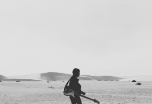 Guitarist walking alone
